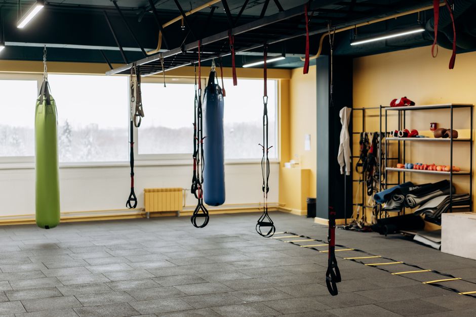 Spacious gym interior with rows of weights and training equipment